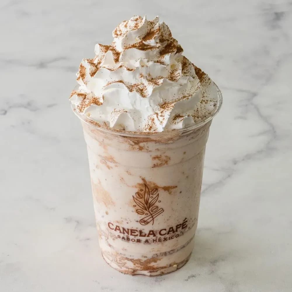 An iced dulce de leche drink in a Canela Café cup